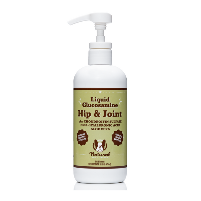 A white pump bottle from Natural Dog Company is labeled Hip & Joint Oil for pets, containing chondroitin sulfate, MSM, hyaluronic acid, and aloe vera. The label features dog and cat silhouettes highlighting its natural benefits for canine joint support.