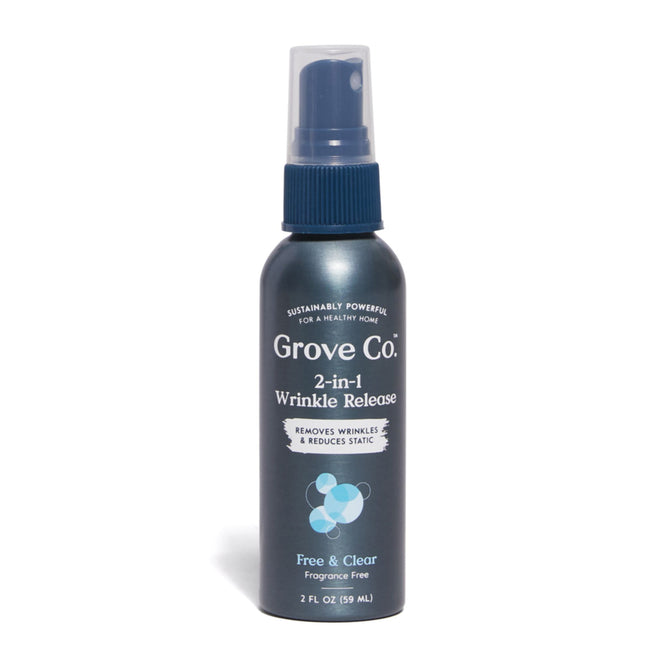 The Grove Co. 2-in-1 Wrinkle Release - Travel Size is displayed with a dark blue label and white text. This 2 fl oz (59 mL) fragrance-free, sustainably powerful spray is plastic-free and ideal for travel, featuring a convenient spray nozzle for easy use.