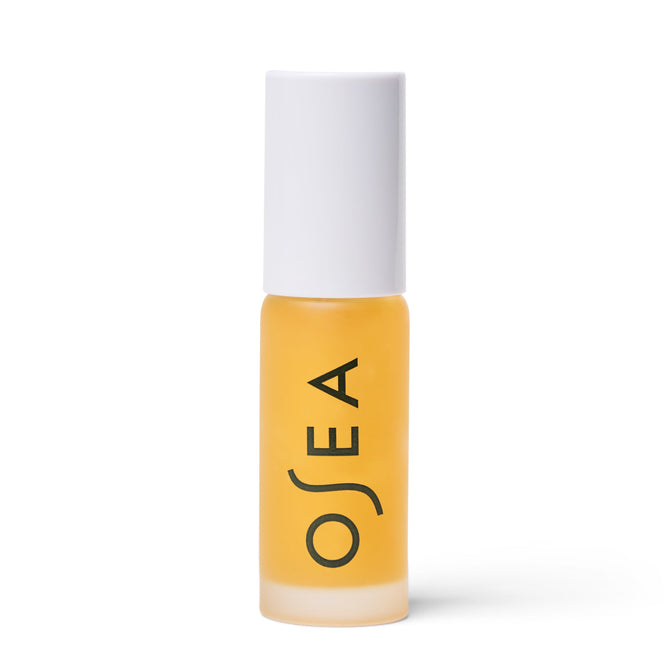 A small transparent bottle with a white cap, filled with yellow liquid, promises plumping hydration. OSEA is printed vertically in black, hinting at the nourishing blend of Hyaluronic Acid Lip Booster.