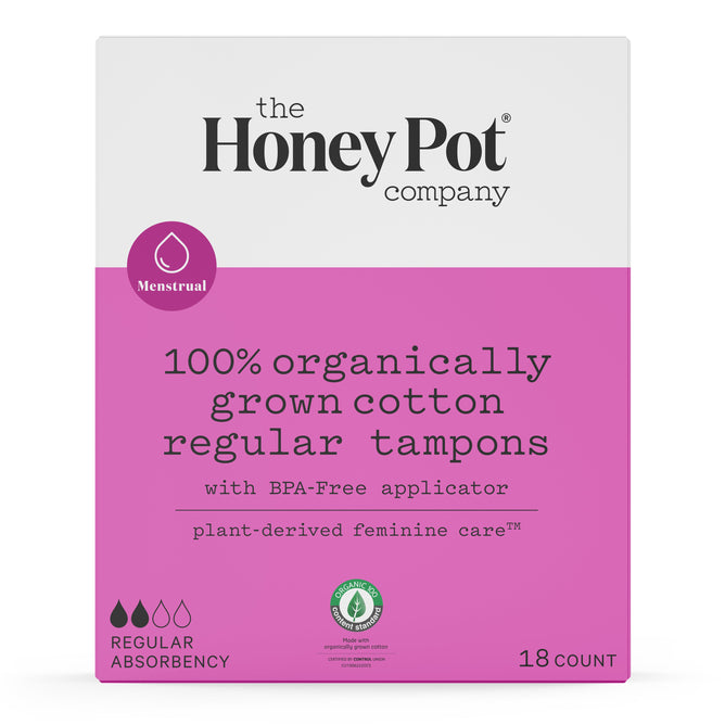 The image showcases The Honeypot Companys 100% Organic Regular Tampons, featuring pink and white packaging that highlights BPA-free, unscented tampons with plant-derived care for reliable leak protection. The box contains 18 regular absorbency tampons.