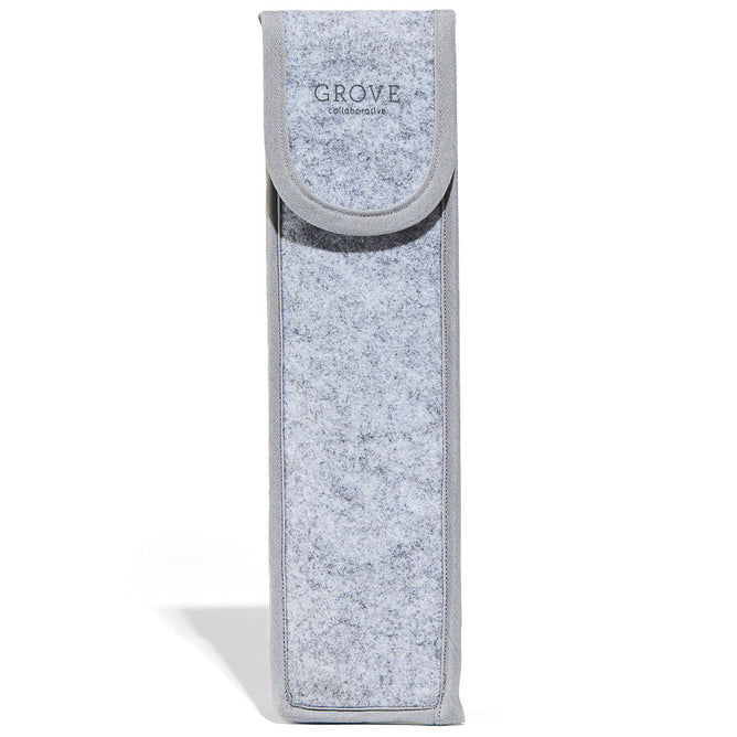 The Grove Co. Glass Straw Case is a tall, rectangular, gray felt pouch made from recycled PET with a flap closure. GROVE is printed near the top, showcasing its dedication to reducing plastic waste through innovations like reusable glass straws.