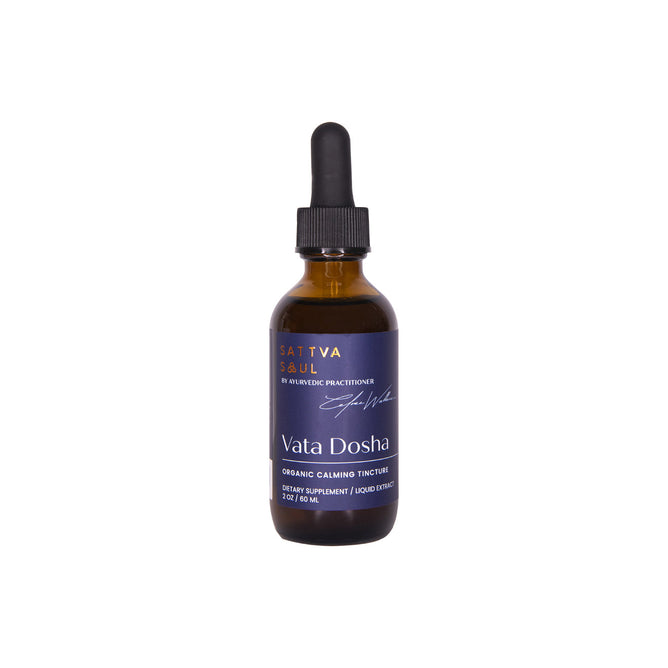 A 2 fl oz brown glass bottle with a dropper lid marked as Sattva Soul Organic Vata Tincture - Calming showcases a dark blue label with white text, stating Ayurvedic herbs and organic calming tincture.