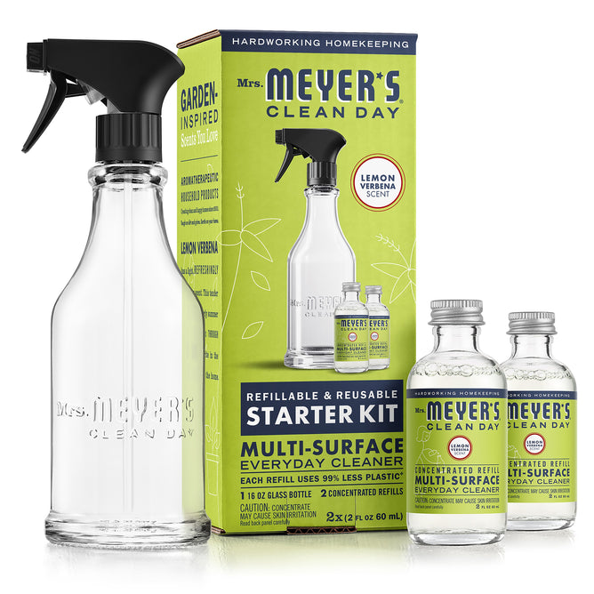 The Multi-Surface Concentrate Starter Set by Mrs. Meyers includes a glass spray bottle, two small multi-surface concentrate bottles with garden-inspired lemon verbena scents, and comes in green and yellow packaging highlighting its cruelty-free cleaning formula.