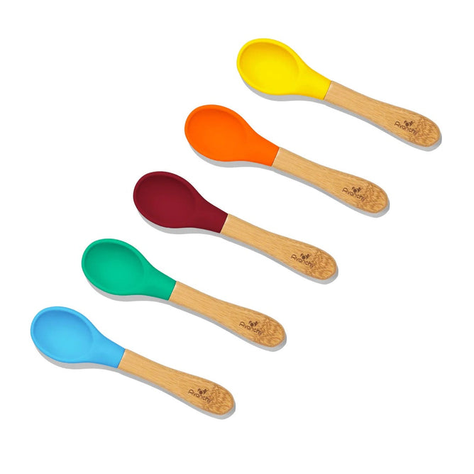 Five Avanchy Bamboo Baby Spoons, each with a wooden handle and vibrant hues of yellow, orange, red, green, and blue, are eco-friendly and arranged diagonally on a white background.