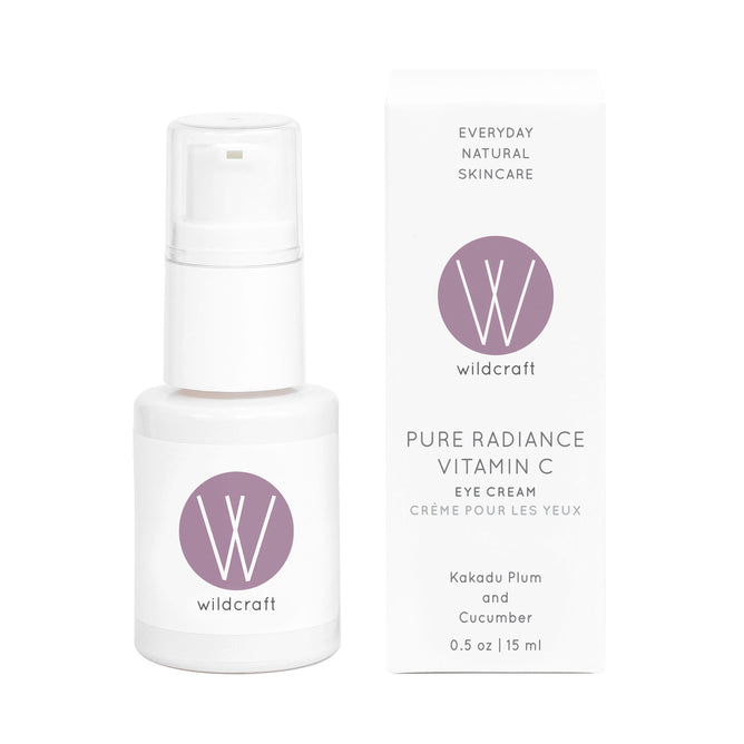 A white bottle of Wildcraft Pure Radiance Vitamin C Eye Cream with a pump dispenser is next to its packaging, showcasing the brand logo and details. It contains Kakadu Plum and Cooling Cucumber for refreshing rejuvenation.