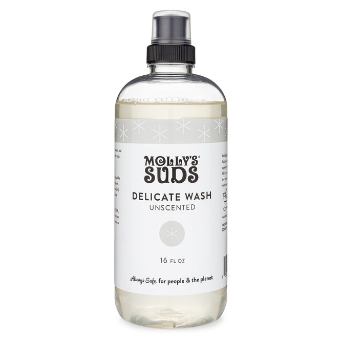 Mollys Suds Delicate Wash, ideal for delicate fabrics, comes in a clear 16 fl oz bottle with a black spray cap. The white label features black text: Delicate Wash Unscented and is adorned with subtle stars and the slogan Always safe for people & the planet, highlighting earth-derived ingredients.