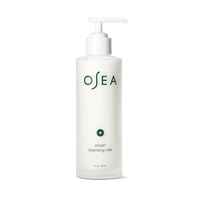 The 150 mL OSEA Ocean Cleansing Milk is a white, pH-balanced, fragrance-free cleanser with a pump dispenser, featuring green text and minimalist design. Dermatologist-approved for gentle skincare.
