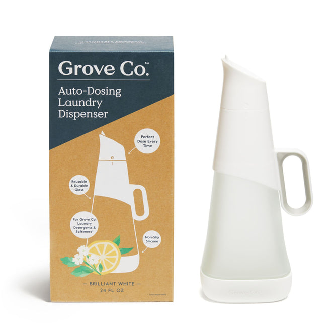 A 24 fl oz Grove Co. Laundry Detergent Dispenser with a non-slip silicone handle is shown beside its packaging, featuring illustrations of the dispenser and a lemon slice with greenery.