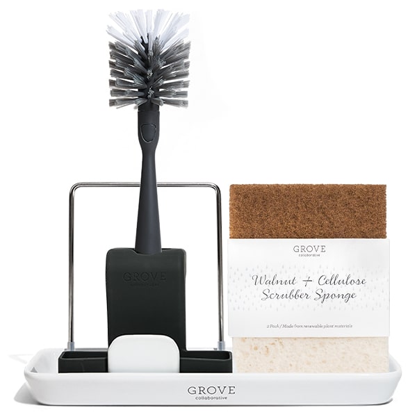 The Sinkside Accessory Set from Grove Co. includes a black dish brush with a stand and a Walnut + Cellulose Scrubber Sponge, all branded with Grove and elegantly organized on a modern stoneware tray, perfect for stylishly arranging your kitchen essentials.