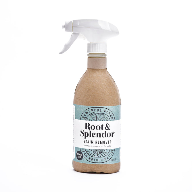 Root & Splendors Stain Remover comes in a spray bottle with paper covering and white label reading Powerful Clean and Foaming Enzyme Action. It features a white spray nozzle and eco-friendly packaging made with natural ingredients.