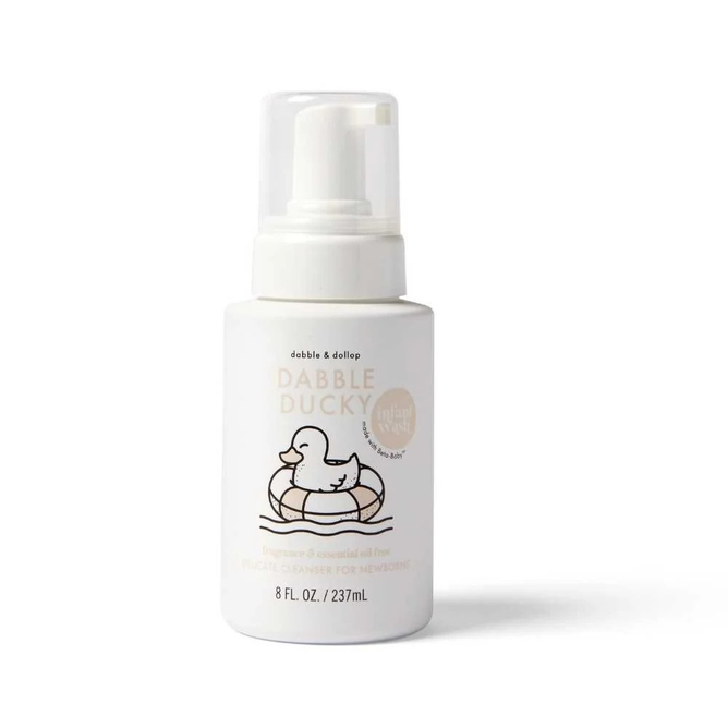 An 8 fl oz (237 ml) white bottle of Dabble & Dollops Dabble Ducky Infant Wash, enriched with beta glucan and featuring a pump dispenser with a duck-in-ring illustration. Its EWG-verified, indicating its fragrance and essential oil-free.