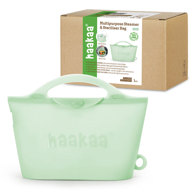 The mint green Haakaa Reusable, Silicone Multipurpose Steamer & Sterilizer Bag has a lid and handle. It comes with a packaging box showing an image of the bag used as a microwave sterilizer and Haakaa boldly printed on both the bag and box.