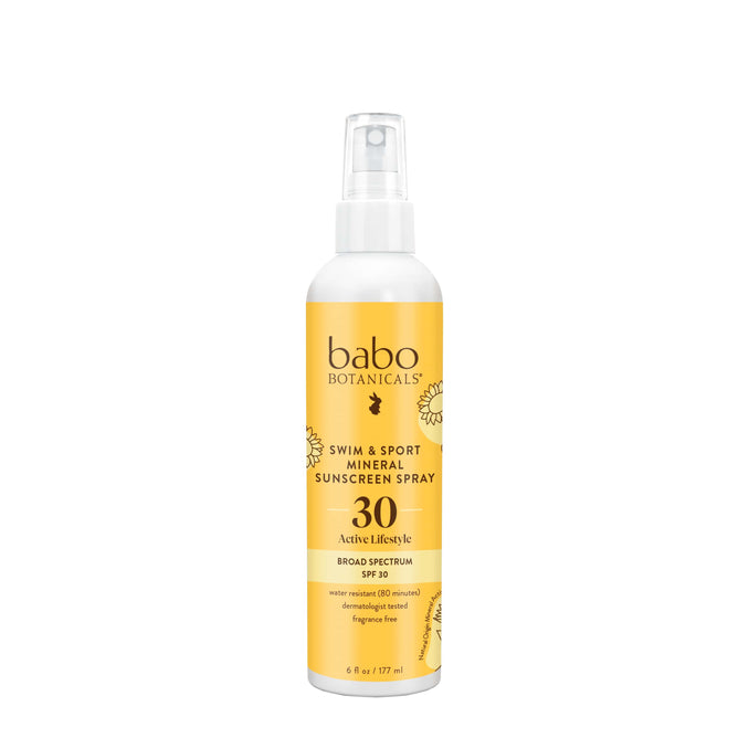 A 6 fl oz (177 ml) white and yellow bottle of Babo Botanicals Swim & Sport Mineral Spray SPF 30 features a non-greasy formula with broad-spectrum UVA/UVB protection, infused with sustainably sourced passion fruit seed oil.