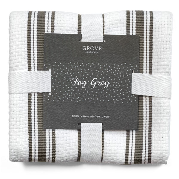 A neatly folded set of Grove Co.s Organic Cotton Classic Kitchen Towels, featuring a textured white and dark stripe pattern, confirms theyre 100% cotton. Secured with white ribbon bands, these essential kitchen towels epitomize useful cleaning accessories for your home.