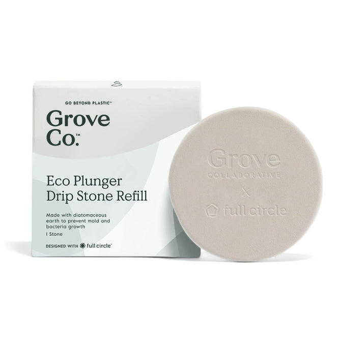An off-white circular Eco Plunger Drip Stone Refill by Grove Co., made with diatomaceous earth for optimal absorption, sits beside its packaging. The packaging touts its ability to prevent mold and bacteria and mentions a design collaboration with Full Circle.