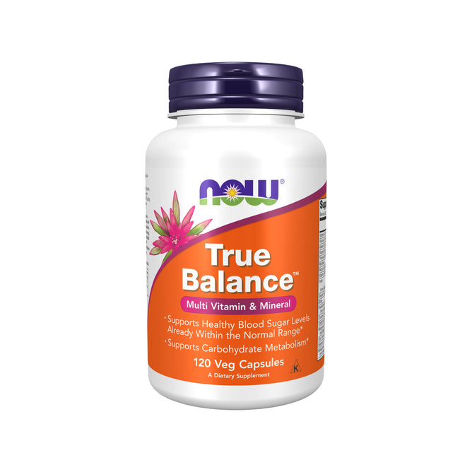 A white bottle with a blue cap from NOW Foods, labeled True Balance - Multi Vitamin & Mineral. It supports blood sugar levels and carbohydrate metabolism, enriched as a biotin supplement, and includes 120 vegetable capsules.