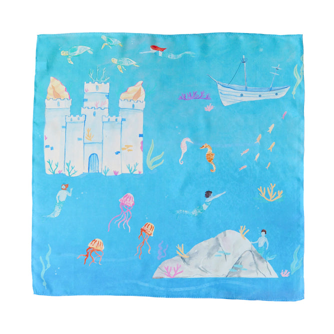 Explore the magic of Sarahs Silks Under the Sea Play Map. This blue Playsilks scarf, dyed with non-toxic colors, displays an underwater world with sandcastles, mermaids, jellyfish, seahorses, boats, and fish schools—a whimsical addition to your aquatic adventures!.