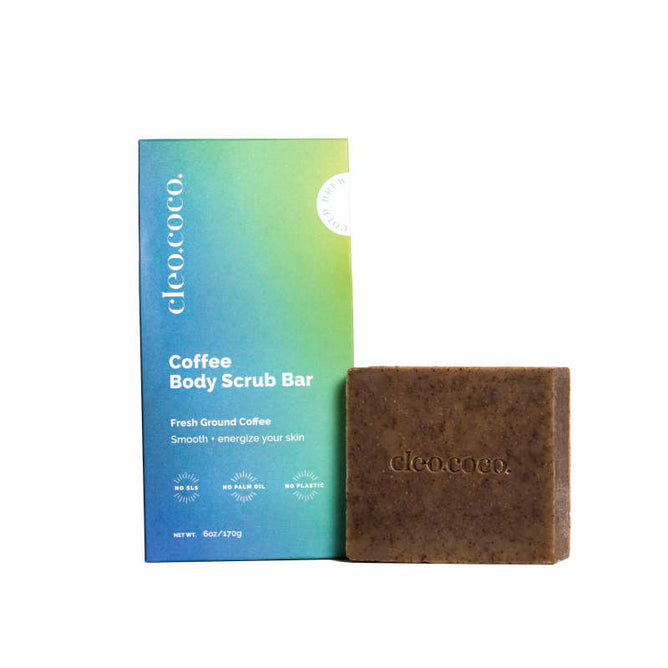 Beside a gradient blue and green Cleo & Coco box is a brown Coffee Body Scrub Bar, highlighting Fresh Ground Coffee to Smooth + energize your skin. Infused with Moroccan clay, it offers a revitalizing experience.