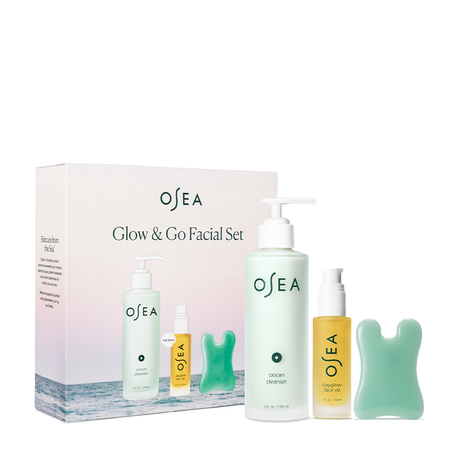 The OSEA Glow & Go Facial Care Starter Set includes an Ocean Cleanser, a vibrant yellow oil, and a green jade gua sha tool, all packaged to reflect the essence of ocean waves for a coastal glow.