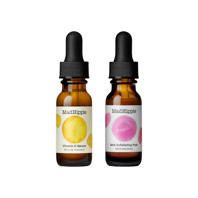 The Mad Hippie AM PM Dual Pack shows two brown dropper bottles; the left has a yellow circle for Vitamin C Serum with antioxidants, and the right features a pink circle for AHA Exfoliating Peel. Both have elegant black caps.