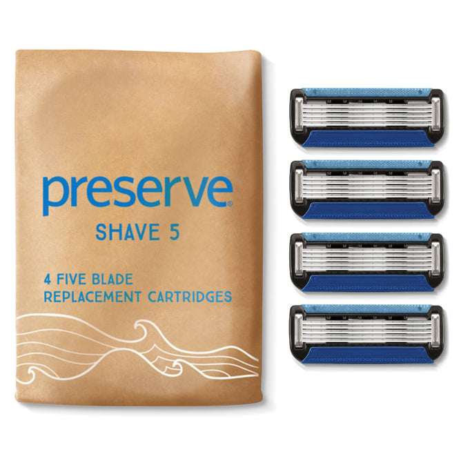 A beige package labeled Shave 5 Replacement Blades contains four five-blade razors. The cartridges, featuring blue and black accents, reflect Preserves dedication to sustainability with their Ocean Plastic technology.