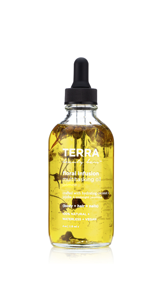 The Terra Beauty Bars Floral Infusion Multitasking Oil for Body + Hair features a clear glass bottle with a black dropper cap, showcasing yellow oil with floral elements. It highlights its jasmine scent and versatility for use on body, hair, and nails.