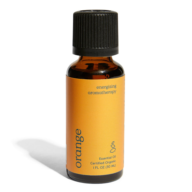 A small amber bottle with a black cap labeled Grove Co. Organic Orange Essential Oil - Energizing Aromatherapy. The vibrant orange label highlights its certified organic status and contains 1 fluid ounce (30 ml).