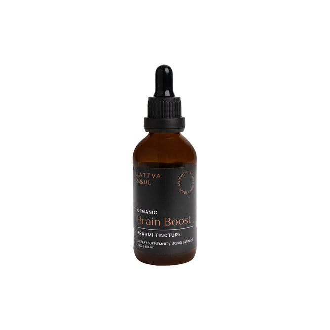 A brown glass dropper bottle, labeled Sattva Soul Organic Brain Boost Tincture with a black label featuring white and gold text, is set against a white background. This Ayurvedic blend serves as a neuro-protective elixir for the mind.