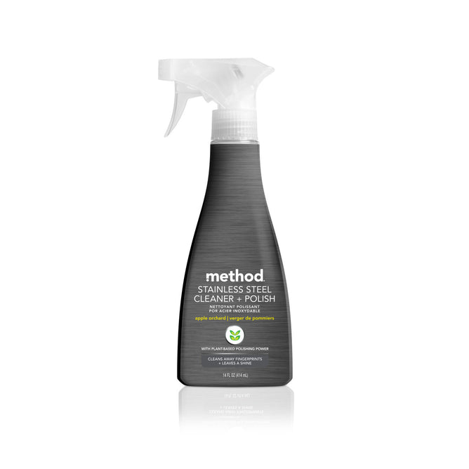The Method Stainless Steel Cleaner + Polish comes in a sleek grey spray bottle with a clear trigger, showcasing an apple orchard scent, plant-based polishing power, and non-toxic formula. Safe for surfaces, it offers a 14 fl oz (414 ml) capacity.