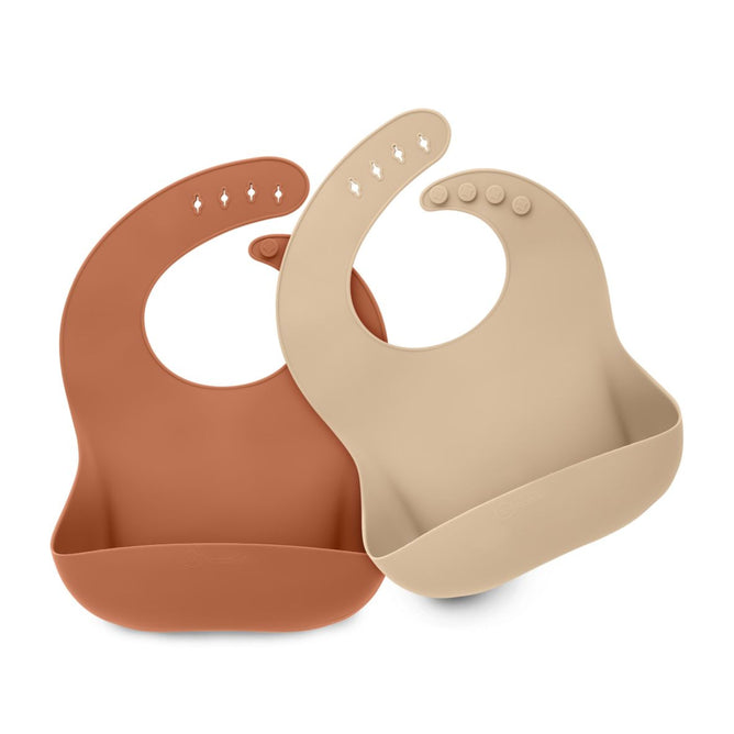The KeaBabies Silicone Bibs set includes two waterproof feeding bibs in warm brown and soft beige. They feature overlapping designs with adjustable neck fasteners, multiple buttonholes, and convenient catch pockets at the bottom.