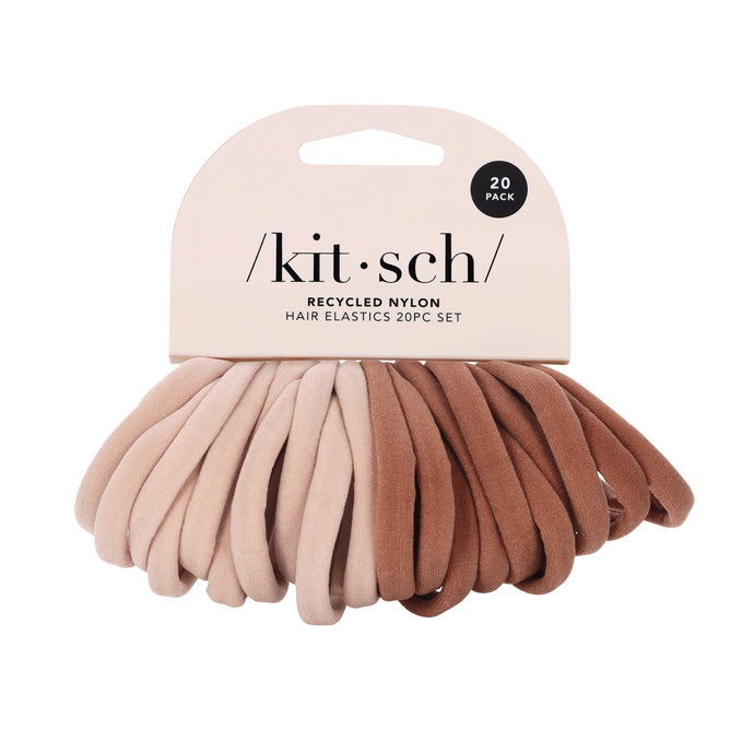 The Kitsch Recycled Nylon Hair Elastics are an eco-friendly essential, featuring 20 hair ties in beige and brown shades. The packaging showcases the brand and product details.