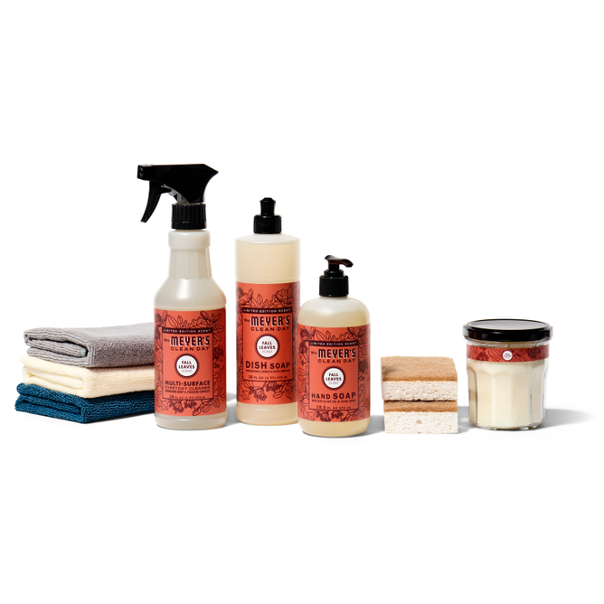 The Grove Collaborative Autumn Abode Starter Set includes Meyers multi-surface spray, dish soap, and hand soap, neatly arranged with folded towels, sponges, and a candle on a white background.