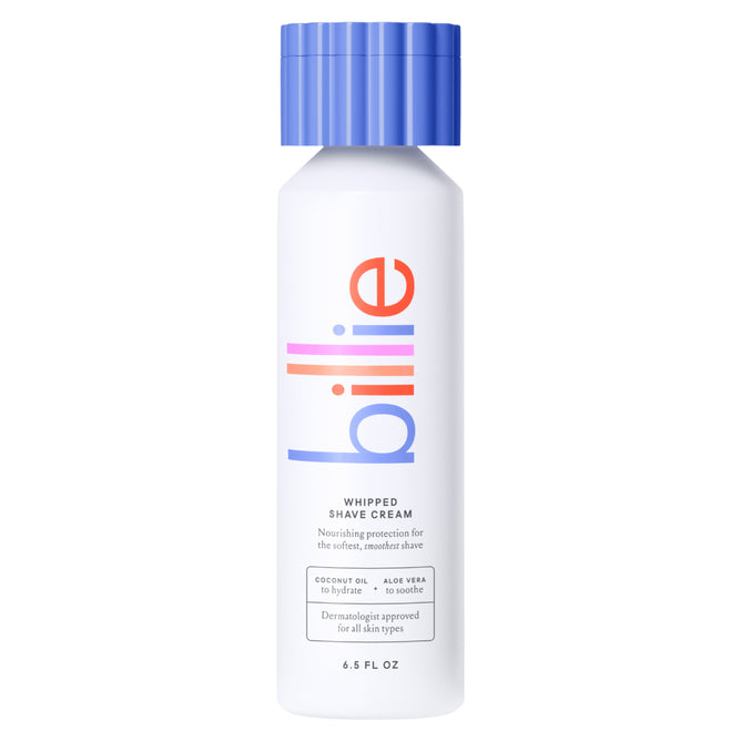 A 6.5 fl oz white bottle of billie Whipped Shave Cream with a blue cap and colorful billie label features nourishing coconut oil, aloe vera, and shea butter, perfect for use with a Billie razor.
