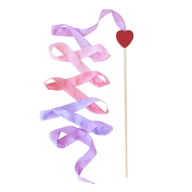The Heart Streamer from Sarahs Silks features a wooden stick with a red heart on top, adorned with artistic pink and purple streamers. Its perfect for pretend play, enhancing creativity and gross motor skills as the ribbons cascade diagonally on the white background.