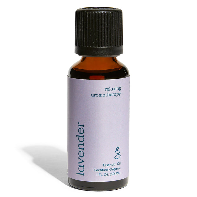A small amber bottle of Grove Co. Organic Lavender Essential Oil features a black cap and a light purple label reading Relaxing Aromatherapy, highlighting its soothing properties, and indicates the volume: 1 FL OZ (30 mL).