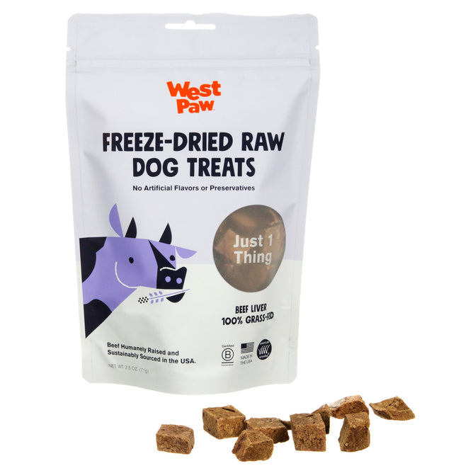 The packaging of West Paws Beef Liver Freeze Dried Raw Single Ingredient Dog Treats is shown, featuring white packaging with playful purple and black dog graphics. The label reads Just 1 Thing - 100% Grass-Fed Beef Liver, with enticing treat pieces displayed in front.