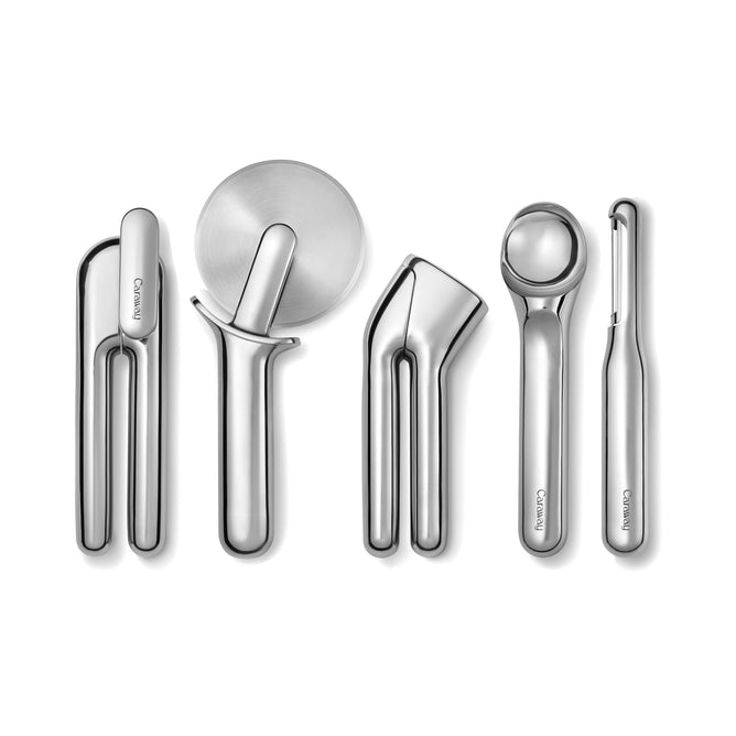 The 5-Piece Stainless Steel Kitchen Gadget Set by Caraway includes sleek essentials like a bottle opener and pizza cutter on a white background. Each utensil features an ergonomic design with the Caraway brand engraved, blending functionality with modern elegance.