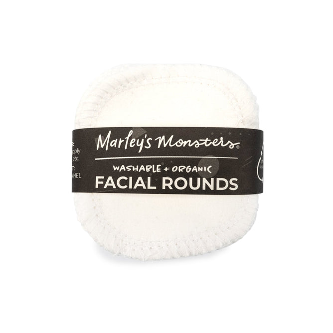 A stack of Reusable Organic Cotton Facial Rounds by Marleys Monsters is wrapped in a black band reading Marleys Monsters Washable Organic Facial Rounds, offering an eco-friendly option for sustainable facial care.