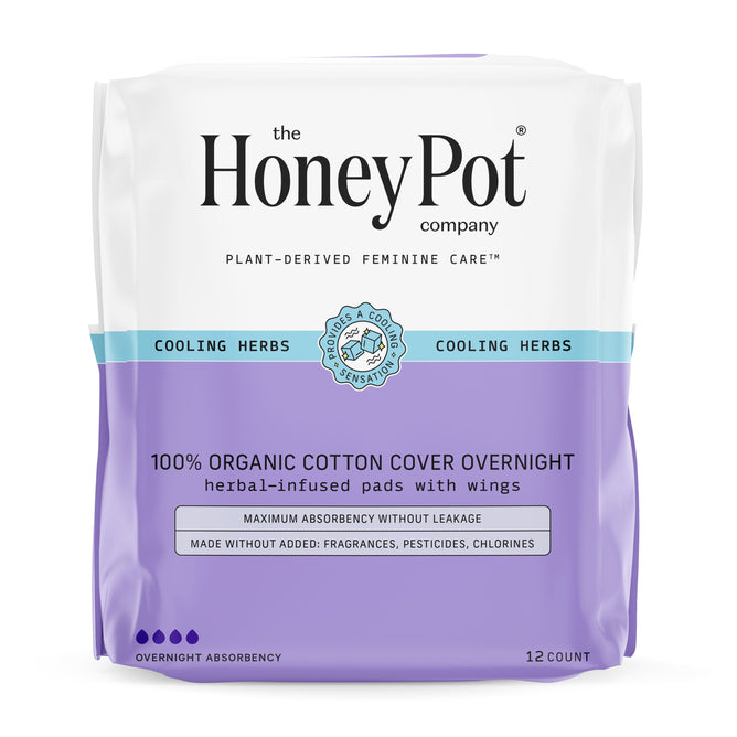 A pack of 12 The Honeypot Company 100% Organic Cotton Cover Overnight Menstrual Pads - Herbal-Infused features purple and white packaging stating cooling herbs and promises maximum absorbency with essential oil infusion, all without added fragrances.