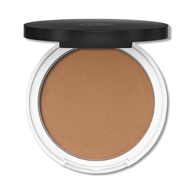 A round compact of Lily Lolos Pressed Bronzer in a neutral brown shade features a white base and black lid. When open, it reveals mineral-enriched powder for a sun-kissed glow.