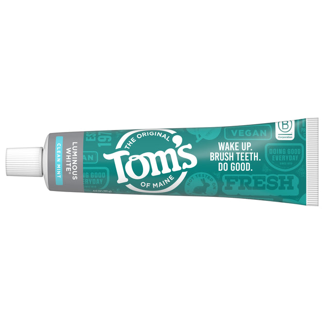 A tube of Toms of Maine Luminous White Anticavity Toothpaste features Fluoride-Free Clean Mint on eco-friendly packaging, highlighting qualities like Vegan and Doing Good Everyday, with white, teal, and green accents.