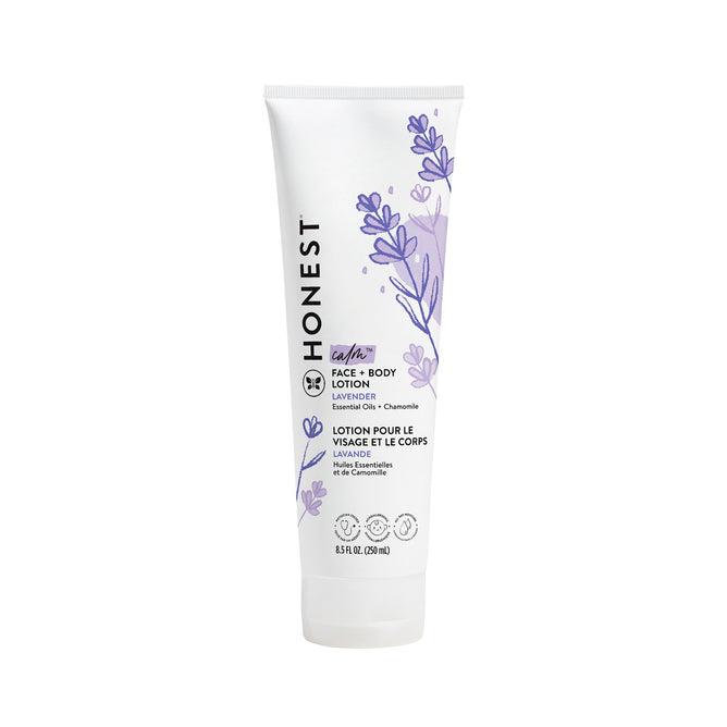 A white tube of The Honest Companys Face + Body Lotion, with naturally derived lavender and chamomile ingredients. It features lavender illustrations and a bilingual English/French label. Suitable for all skin types, the 8.5 fl oz (250 ml) lotion is perfect for your skincare routine.