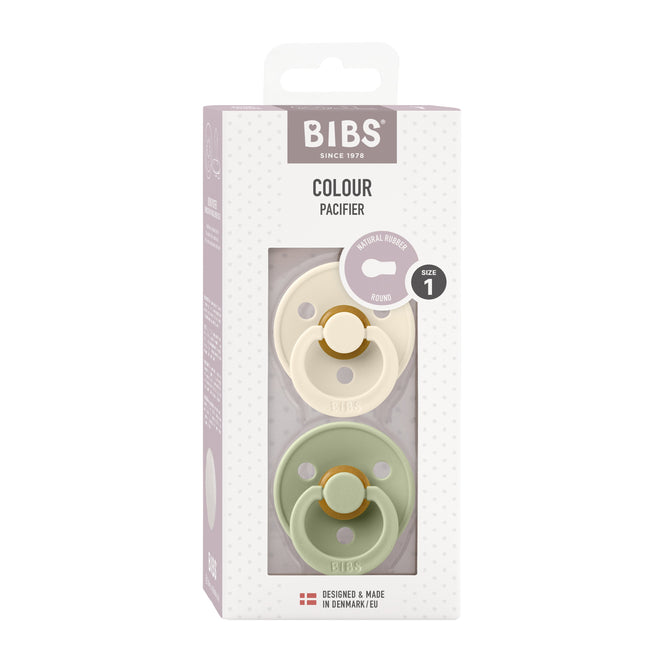 A BIBS packaging box includes two BPA-free, natural latex rubber pacifiers: one cream and one pale green. The top shows BIBS and Colour Pacifier. A Danish flag and Size 1 (0-6 Months) are noted, offering breastfeeding support for your baby.
