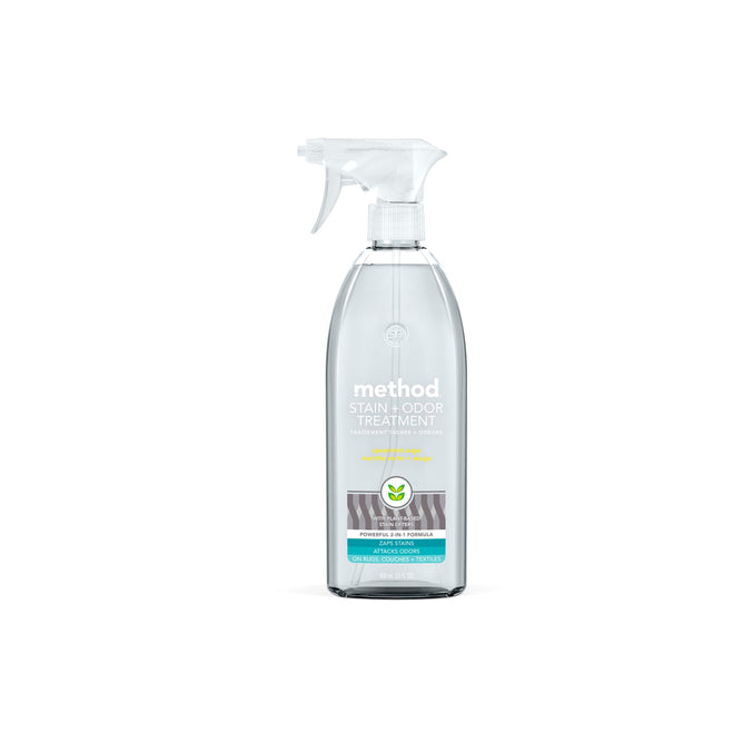 A clear spray bottle with a white nozzle labeled method Stain and Odor Treatment Spray features powerful stain lifters and odor fighters. The blue and white label pops against the plain background, emphasizing its ability to tackle tough messes easily.