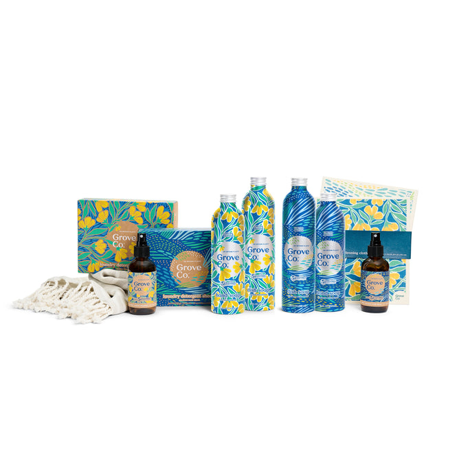 Grove Collaboratives limited edition Complete Set - Spring Collection features cleaning products with vibrant floral designs. The set includes two spray bottles, a boxed collection, and cleaning cloths, all elegantly displayed on a crisp white backdrop.