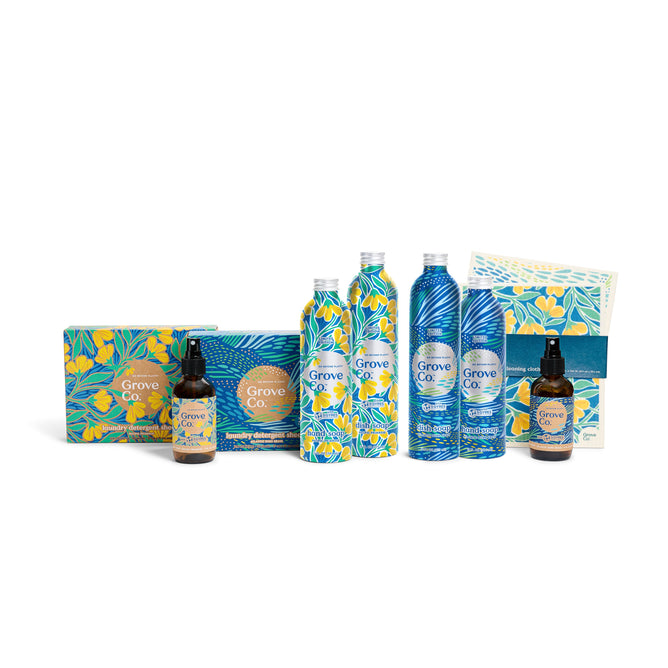 Introducing the Grove Collaborative Fresh Home Cleaning Set - Spring Collection: a limited edition of essentials featuring tall and pump bottles, plus boxed items. Enjoy vibrant floral and leaf designs in blue and yellow with prominent branding on each piece.