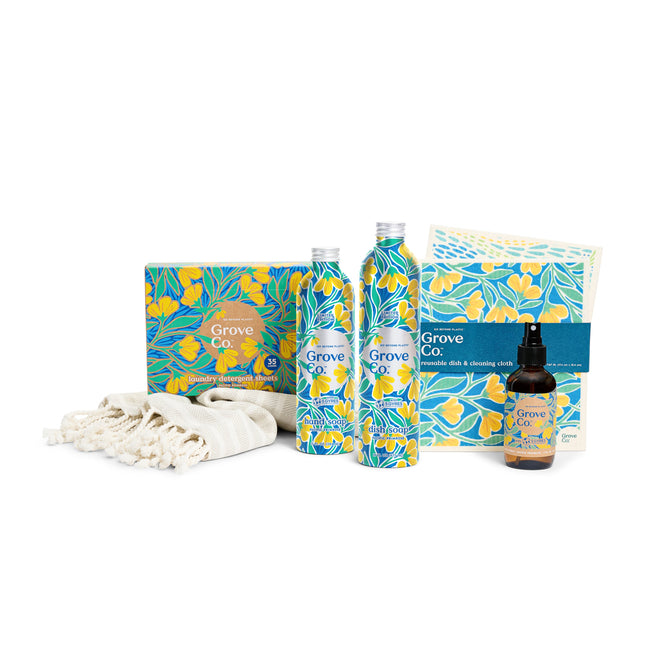 Explore Grove Collaboratives Scent Essentials - Spring Collection, featuring two bottles and a spray adorned with Pacific Primrose floral designs in blue, yellow, and green, alongside a cream-colored cloth with tasseled ends.