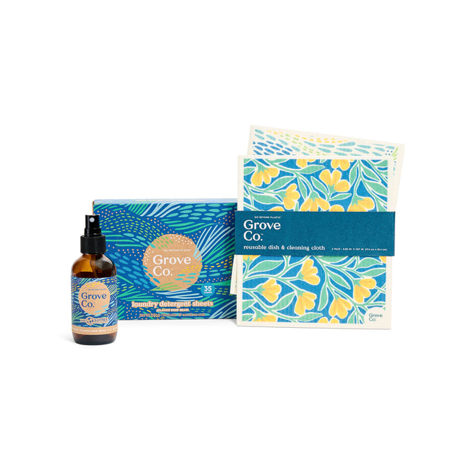 Explore the Grove Collaborative Coastal Air & Laundry Set from the Spring Collection, featuring a cleaning spray and reusable dish and cleaning cloths, each with vibrant floral designs inspired by Atlantic Dune Grass in blue, yellow, and green.