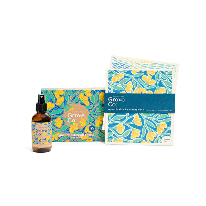 Grove Collaboratives Coastal Air & Laundry set from the Spring Collection includes a spray bottle, laundry detergent sheets, and reusable dish cloths in yellow and blue floral packaging with Pacific Primrose and Atlantic Dune Grass patterns.