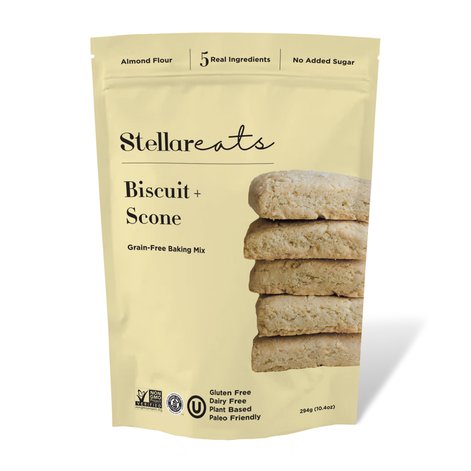 A beige bag of Stellar Eats Biscuit + Scone Mix, featuring stacked scones, highlights 5 Real Ingredients, No Added Sugar, Gluten Free, Dairy Free, and Plant Based on its grain-free packaging. With almond flour, its a paleo-friendly treat.
